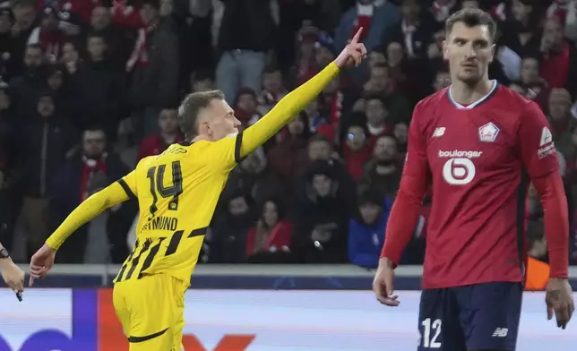 Dortmund's Maximilian Beier celebrates after scoring during the Champions League round of 16 second leg soccer match between Lille and Borussia Dortmund in Villeneuve-d'Ascq , Wednesday, March 12, 2025. (AP Photo/Michel Euler)