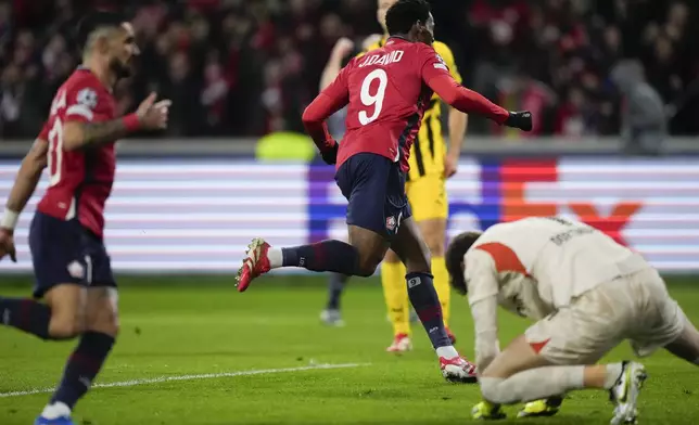 Lille's Jonathan David celebrates after scoring during the Champions League round of 16 second leg soccer match between Lille and Borussia Dortmund in Villeneuve-d'Ascq , Wednesday, March 12, 2025. (AP Photo/Michel Euler)