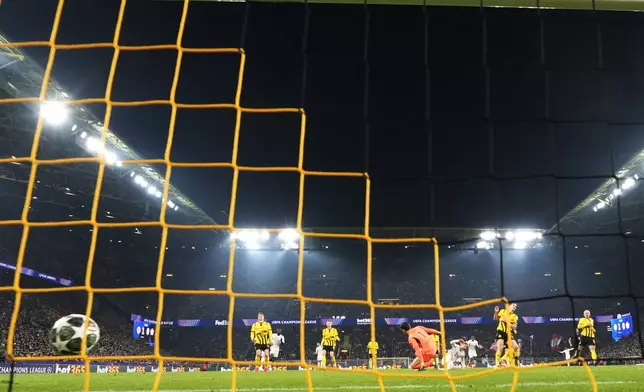 Lille's Hakon Arnar Haraldsson scores his side's first goal during the Champions League round of 16 first leg soccer, between Borussia Dortmund and Lille at the Signa-Iduna Park in Dortmund, Germany, Tuesday, March 4, 2025. (AP Photo/Martin Meissner)