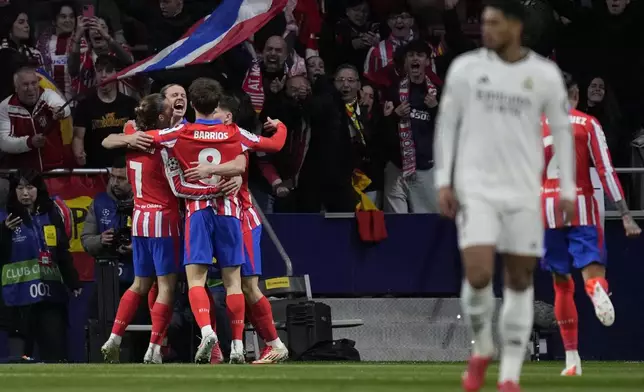 Atletico Madrid players celebrate after a goal during the Champions League round of 16, second leg, soccer match between Atletico Madrid and Real Madrid at the Metropolitano stadium in Madrid, Spain, Wednesday, March 12, 2025. (AP Photo/Bernat Armangue)