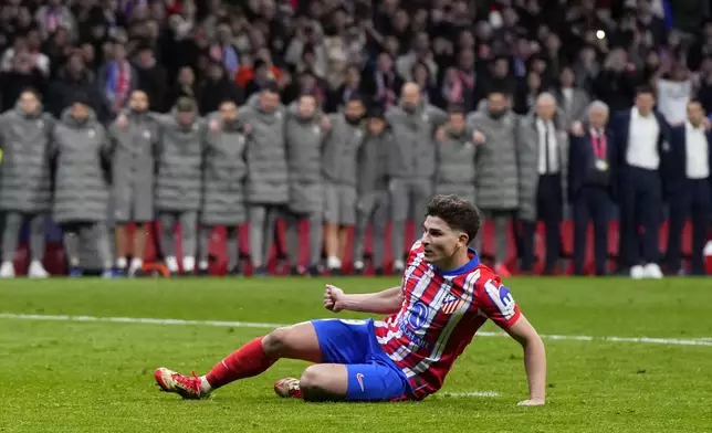 Atletico Madrid's Julian Alvarez falls to the ground after taking a penalty kick during a shootout at the end of the Champions League round of 16, second leg, soccer match between Atletico Madrid and Real Madrid at the Metropolitano stadium in Madrid, Spain, Wednesday, March 12, 2025. (AP Photo/Manu Fernandez)