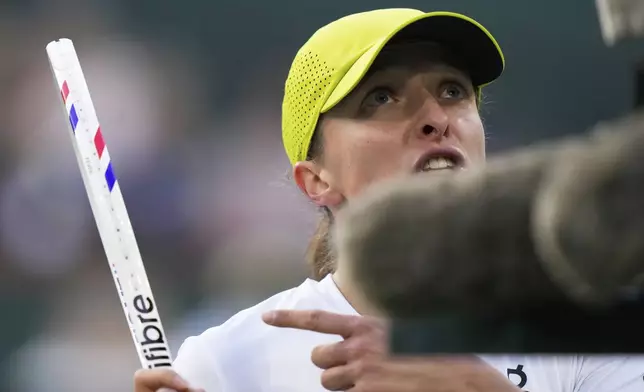 Iga Swiatek, of Poland, gestures while talking with the chair umpire as she plays against Mirra Andreeva, of Russia, during the semifinals at the BNP Paribas Open tennis tournament Friday, March 14, 2025, in Indian Wells, Calif. (AP Photo/Mark J. Terrill)