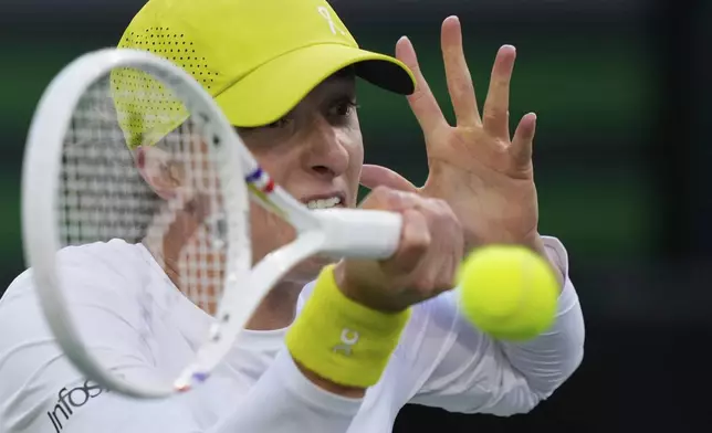 Iga Swiatek, of Poland, returns to Mirra Andreeva, of Russia, during the semifinals at the BNP Paribas Open tennis tournament Friday, March 14, 2025, in Indian Wells, Calif. (AP Photo/Mark J. Terrill)
