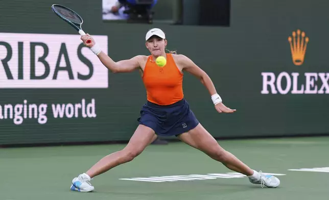Mirra Andreeva, of Russia, returns to Iga Swiatek, of Poland, during the semifinals at the BNP Paribas Open tennis tournament Friday, March 14, 2025, in Indian Wells, Calif. (AP Photo/Mark J. Terrill)