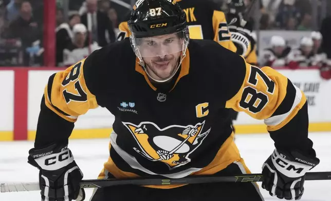 Pittsburgh Penguins' Sidney Crosby prepares to take a face-off during the second period of an NHL hockey game against the New Jersey Devils in Pittsburgh, Saturday, March 15, 2025. (AP Photo/Gene J. Puskar)