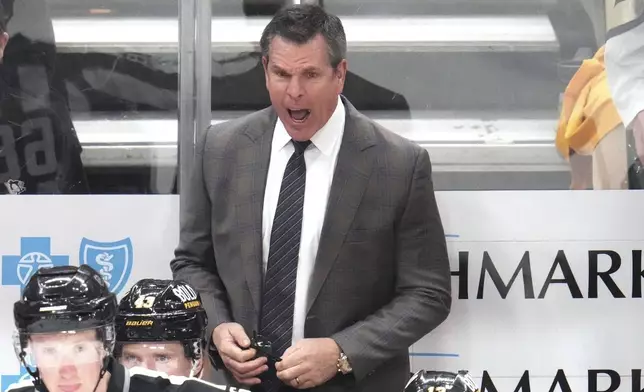 Pittsburgh Penguins head coach Mike Sullivan stands behind his bench during the third period of an NHL hockey game against the Vegas Golden Knights in Pittsburgh, Tuesday, March 11, 2025. (AP Photo/Gene J. Puskar)