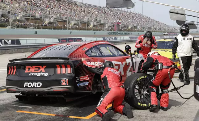Crew members for Josh Berry work on his car after spinning on pit road during a NASCAR Cup Series auto race at Homestead-Miami Speedway in Homestead, Fla., Sunday, March 23, 2025. (AP Photo/Terry Renna)