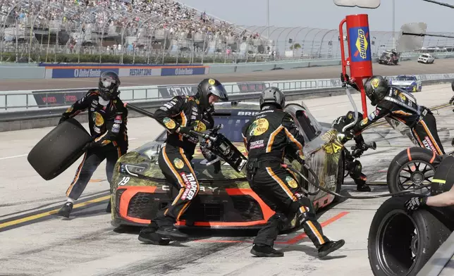 Crew members for Chase Briscoe perform a pitstop during a NASCAR Cup Series auto race at Homestead-Miami Speedway in Homestead, Fla., Sunday, March 23, 2025. (AP Photo/Terry Renna)