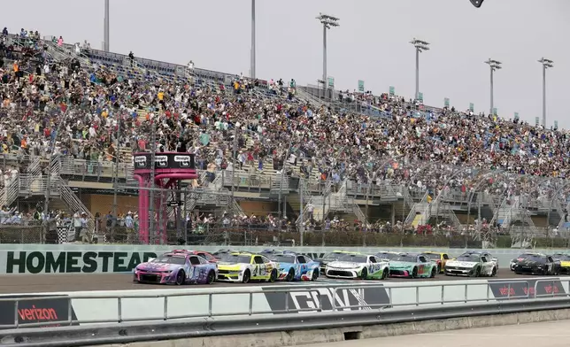 Alex Bowman (48) leads the field to start a NASCAR Cup Series auto race at Homestead-Miami Speedway in Homestead, Fla., Sunday, March 23, 2025. (AP Photo/Terry Renna)