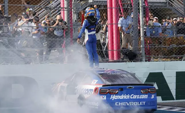 Kyle Larson celebrates after winning a NASCAR Cup Series auto race at Homestead-Miami Speedway in Homestead, Fla., Sunday, March 23, 2025. (AP Photo/Terry Renna)