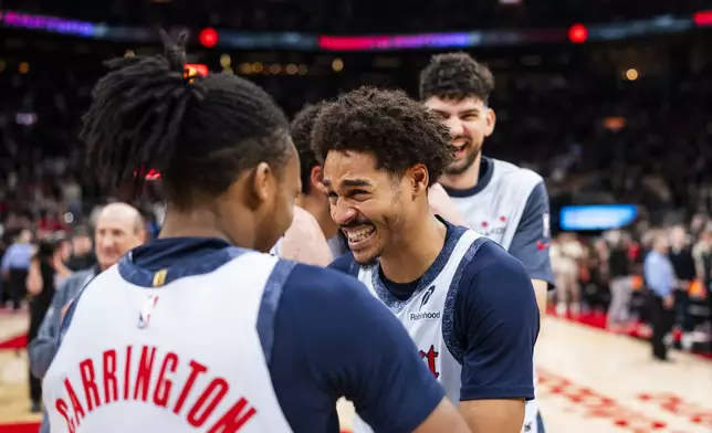 Washington Wizard guard Jordan Poole (13) and guard Bub Carrington (8) react to the Toronto Raptors potential game-winning point being overturned leading to a Wizards win following NBA action in Toronto on Saturday, March 8, 2025. (Thomas Skrlj/The Canadian Press via AP)