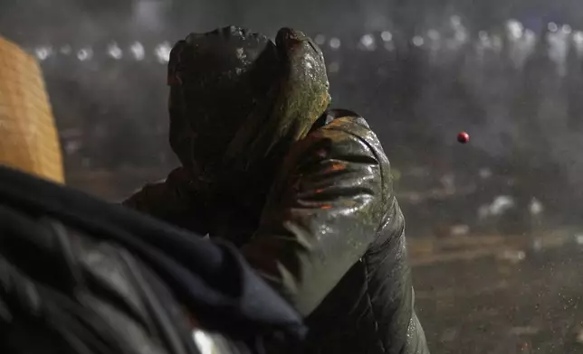 Riot police fire tear gas pellets to disperse protesters during a protest against the arrest of Istanbul's Mayor Ekrem Imamoglu, in Istanbul, Turkey, Saturday, March 22, 2025. (AP Photo/Francisco Seco)