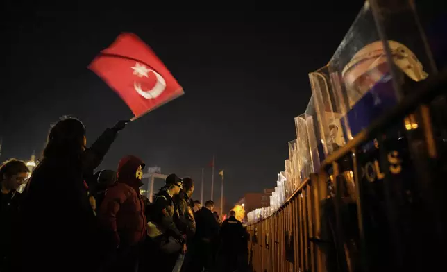 A protester waves Turkish flag during a protest against the arrest of Istanbul's Mayor Ekrem Imamoglu, outside Caglayan courthouse, in Istanbul, Turkey, Saturday, March 22, 2025. (AP Photo/Emrah Gurel)