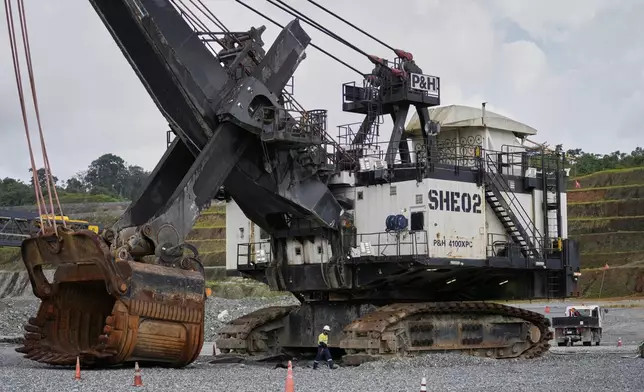 An excavator sits idle at the Cobre Panamá copper mine, owned by Canada's First Quantum Minerals, in Donoso, Panama, Friday, March 21, 2025, during a press tour of the mine that was closed after Panama's Supreme Court ruled that the government concession was unconstitutional. (AP Photo/Matias Delacroix)