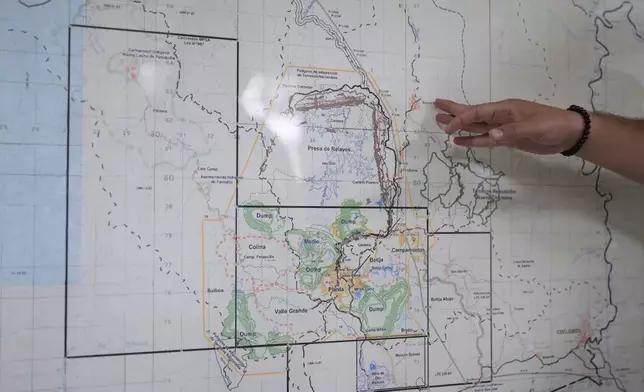 An engineer shows the location of the Cobre Panama copper mine, owned by Canada's First Quantum Minerals, during a press tour of the mine that was closed after Panama's Supreme Court ruled that the government concession was unconstitutional, in Donoso, Panama, Friday, March 21, 2025. (AP Photo/Matias Delacroix)