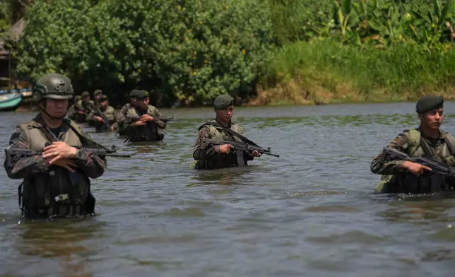 Guatemalan soldiers patrol the shared border with Mexico as part of the Ring of Fire operation, aiming to strengthen border control, at the mouth of Suchiate River in Ocos, Guatemala, Thursday, March 13, 2025. (AP Photo/Moises Castillo)