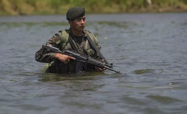 A Guatemalan soldier patrols the shared border with Mexico as part of the Ring of Fire operation, aiming to strengthen border control, at the mouth of Suchiate River in Ocos, Guatemala, Thursday, March 13, 2025. (AP Photo/Moises Castillo)
