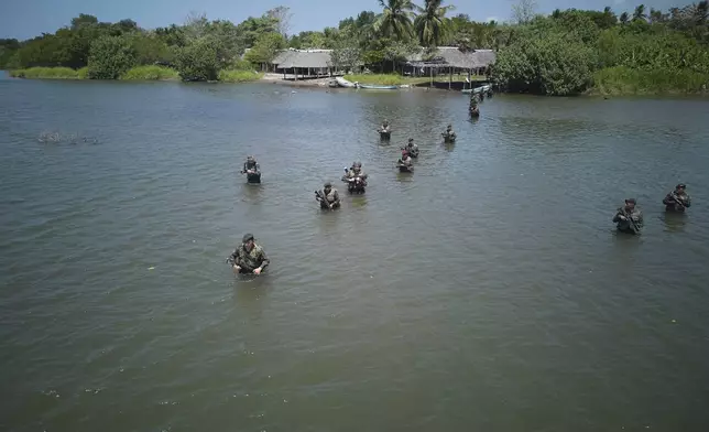 Guatemalan soldiers patrol the shared border with Mexico as part of the Ring of Fire operation, aiming to strengthen border control, in the Suchiate River in Ocos, Guatemala, Thursday, March 13, 2025. (AP Photo/Moises Castillo)