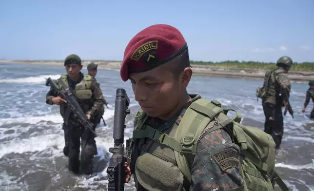 A member of the Kaibiles special force unit patrols the shared border with Mexico as part of the Ring of Fire operation, aiming to strengthen border control, at the mouth of the Suchiate River in Ocos, Guatemala, Thursday, March 13, 2025. (AP Photo/Moises Castillo)