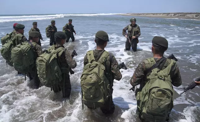 Army Colonel Juan Celis Mendizabal, top, gives instructions to soldiers as they patrol the shared border with Mexico as part of the Ring of Fire operation, aiming to strengthen border control in the Suchiate River in Ocos, Guatemala, Thursday, March 13, 2025. (AP Photo/Moises Castillo)