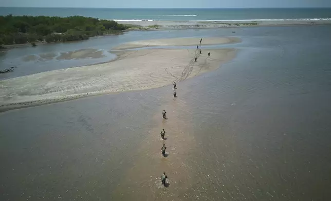 Guatemalan soldiers patrol the shared border with Mexico as part of the Ring of Fire operation, aiming to strengthen border control, at the mouth of Suchiate River in Ocos, Guatemala, Thursday, March 13, 2025. (AP Photo/Moises Castillo)