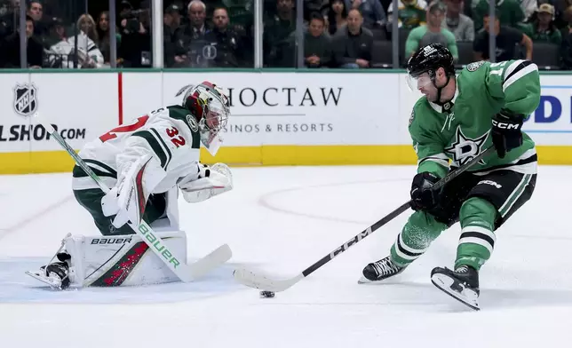 Dallas Stars center Colin Blackwell (15) attempts to shoot past Minnesota Wild goaltender Filip Gustavsson (32) during an NHL hockey game in Dallas, Monday, March 24, 2025. (AP Photo/Gareth Patterson)