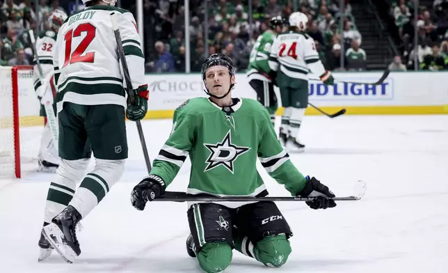 Dallas Stars center Roope Hintz, front right, reacts after being called for interference against Minnesota Wild left wing Matt Boldy (12) during an NHL hockey game in Dallas, Monday, March 24, 2025. (AP Photo/Gareth Patterson)