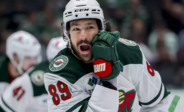 Minnesota Wild center Frederick Gaudreau (89) yells to his teammate before a face-off in an NHL hockey game against the Dallas Stars in Dallas, Monday, March 24, 2025. (AP Photo/Gareth Patterson)