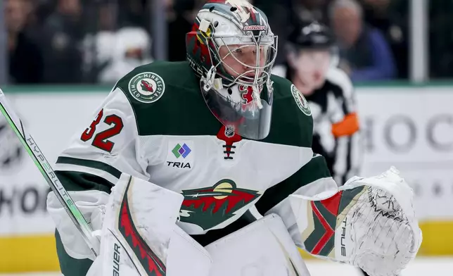 Minnesota Wild goaltender Filip Gustavsson (32) prepares to defend during a face-off in an NHL hockey game against the Dallas Stars in Dallas, Monday, March 24, 2025. (AP Photo/Gareth Patterson)