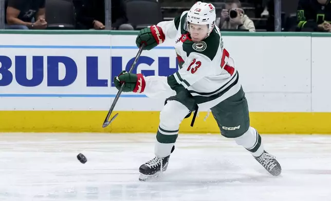Minnesota Wild center Marco Rossi shoots during an NHL hockey game against the Dallas Stars in Dallas, Monday, March 24, 2025. (AP Photo/Gareth Patterson)