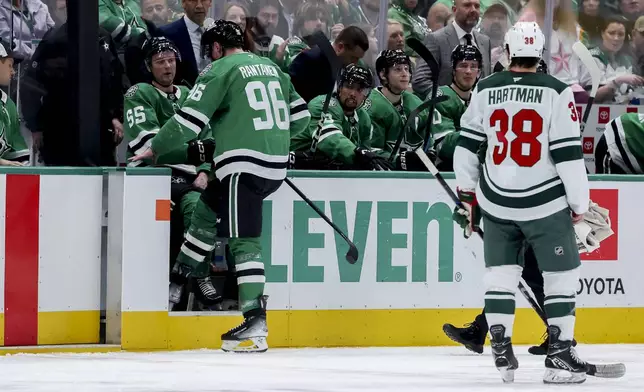 Dallas Stars right wing Mikko Rantanen (96) exits after taking a puck to the face during an NHL hockey game against the Minnesota Wild in Dallas, Monday, March 24, 2025. (AP Photo/Gareth Patterson)