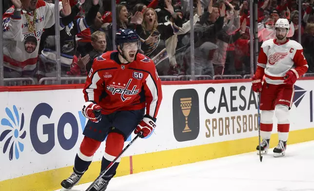 Washington Capitals right wing Taylor Raddysh, left, celebrates after scoring against the Detroit Red Wings during the first period of an NHL hockey game, Friday, March 7, 2025, in Washington. (AP Photo/Nick Wass)
