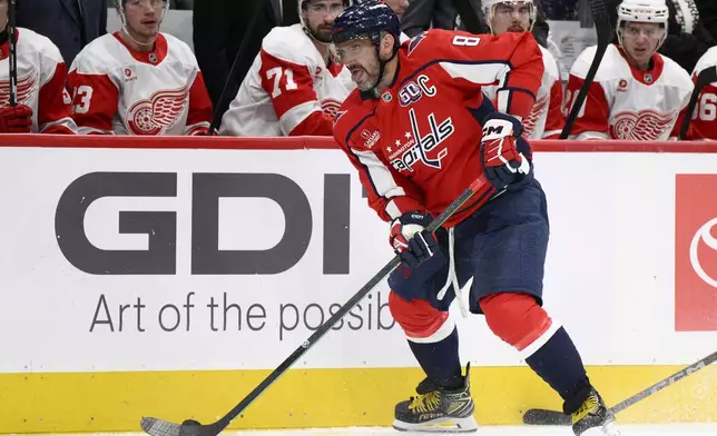 Washington Capitals left wing Alex Ovechkin (8) skates with the puck during the second period of an NHL hockey game against the Detroit Red Wings, Friday, March 7, 2025, in Washington. (AP Photo/Nick Wass)