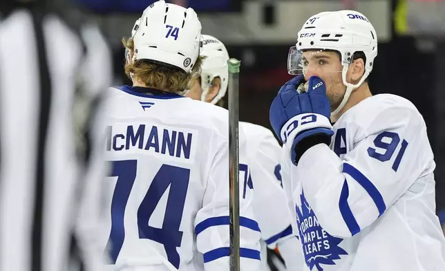 Toronto Maple Leafs centers Bobby McMann (74) and John Tavares (91) talk during the first period of an NHL hockey game against the New York Rangers, Thursday, March 20, 2025, in New York. (AP Photo/Julia Demaree Nikhinson)