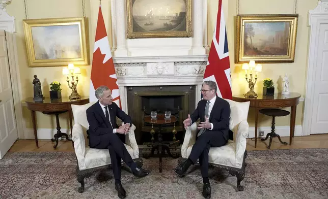Britain's Prime Minister Sir Keir Starmer, right, and Canada's Prime Minister Mark Carney, left, attend a meeting in 10 Downing Street, London, England, Monday March 17, 2025. (Jordan Pettitt/PA via AP, Pool)