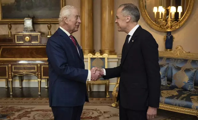King Charles III, left, holds an audience with Canada's Prime Minister Mark Carney, right, at Buckingham Palace in London, England, Monday, March 17, 2025. (Aaron Chown/PA via AP, Pool)
