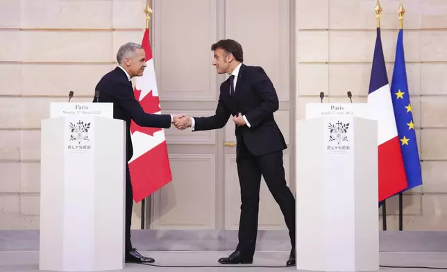 Canada Prime Minister Mark Carney, left, and President of France Emmanuel Macron shake hands after delivering a joint statement at the Palais de l'Elysee in Paris, on Monday, March 17, 2025. (Sean Kilpatrick/The Canadian Press via AP)