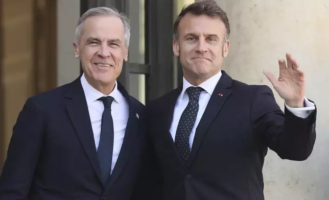 French President Emmanuel Macron, right, welcomes Canada's Prime Minister Mark Carney Monday, March 17, 2025 at the Elysee Palace in Paris. (AP Photo/Thomas Padilla)
