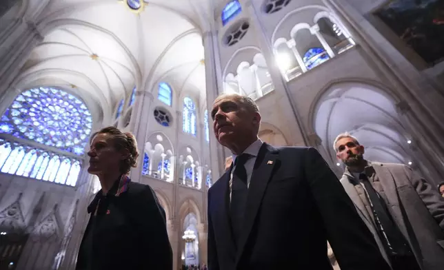 Canada's Prime Minister Mark Carney and wife Diana Fox Carney tour Notre-Dame Cathedral in Paris, Monday, March 17, 2025. (Sean Kilpatrick/The Canadian Press via AP)