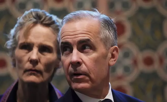 Canada's Prime Minister Mark Carney and wife Diana Fox Carney tour Notre-Dame Cathedral in Paris, Monday, March 17, 2025. (Sean Kilpatrick/The Canadian Press via AP)