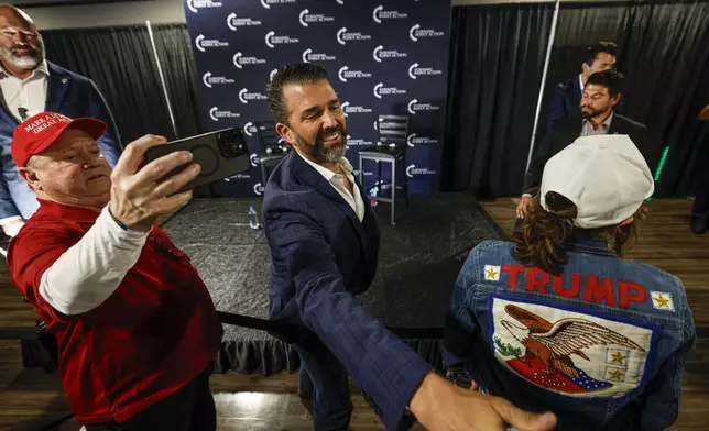 Donald Trump Jr. greets supporters after a town hall meeting Monday, March 17, 2025, in Oconomowoc, Wis. (AP Photo/Jeffrey Phelps)