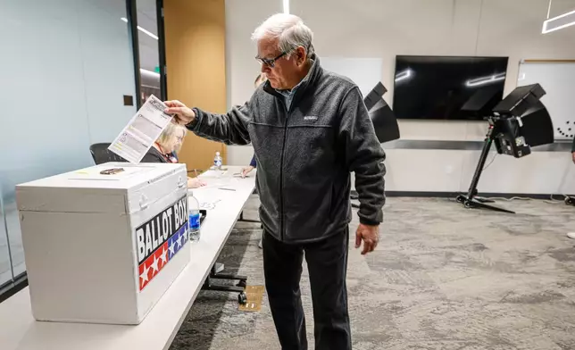 A voter casts a ballot during early voting in Waukesha, Wis., Tuesday, March 18, 2025. (AP Photo/Jeffrey Phelps)