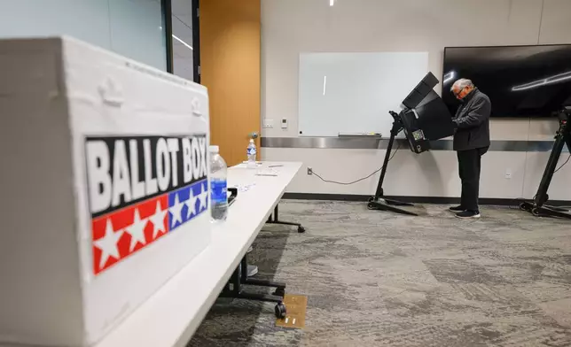 A voter casts a ballot during early voting in Waukesha, Wis., Tuesday, March 18, 2025. (AP Photo/Jeffrey Phelps)