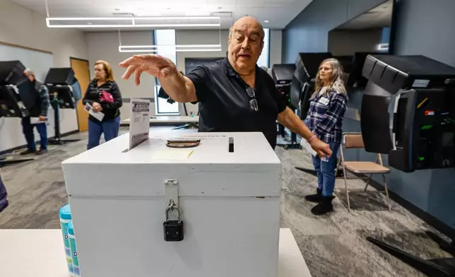A man casts his ballot during early voting in Waukesha, Wis., Tuesday, March 18, 2025. (AP Photo/Jeffrey Phelps)