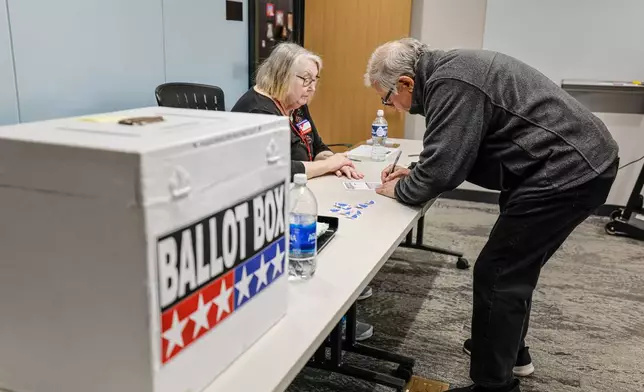 A voter casts a ballot during early voting in Waukesha, Wis., Tuesday, March 18, 2025. (AP Photo/Jeffrey Phelps)