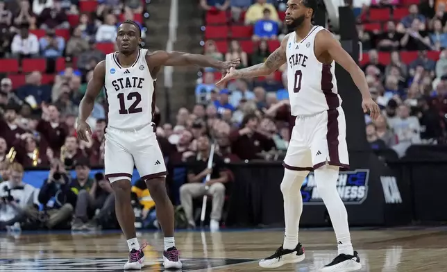 Mississippi State guard Josh Hubbard (12) celebrates with guard Claudell Harris Jr. (0) after making a three-point shot during the first half in the first round of the NCAA college basketball tournament against Baylor, Friday, March 21, 2025, in Raleigh, N.C. (AP Photo/Stephanie Scarbrough)
