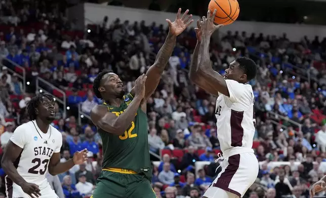 Baylor guard Jalen Celestine (32) and Mississippi State guard Shawn Jones Jr. (5) battle for control of the ball during the first half in the first round of the NCAA college basketball tournament, Friday, March 21, 2025, in Raleigh, N.C. (AP Photo/Stephanie Scarbrough)