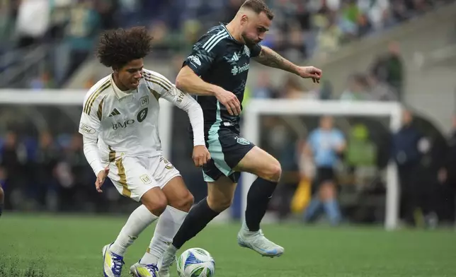 Los Angeles FC forward David Martínez, left, collides with Seattle Sounders forward Jordan Morris near the box and would go on to score during extra time in the second half of an MLS soccer match Saturday, March 8, 2025, in Seattle. (AP Photo/Lindsey Wasson)