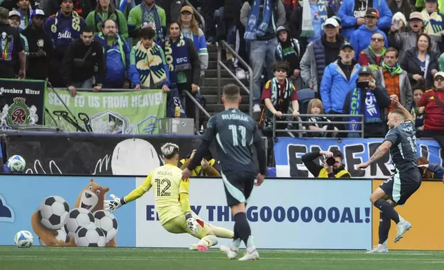 Seattle Sounders forward Jordan Morris, right, shoots and scores in front of Los Angeles FC goalkeeper Thomas Hasal (12) during the second half of an MLS soccer match Saturday, March 8, 2025, in Seattle. (AP Photo/Lindsey Wasson)