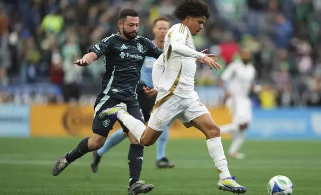 Los Angeles FC forward David Martínez, right, gets past Seattle Sounders midfielder João Paulo to score during extra time in the second half of an MLS soccer match Saturday, March 8, 2025, in Seattle. (AP Photo/Lindsey Wasson)